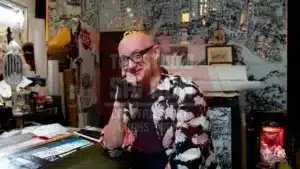 Artist Richie Fawcett sits at his drawing desk